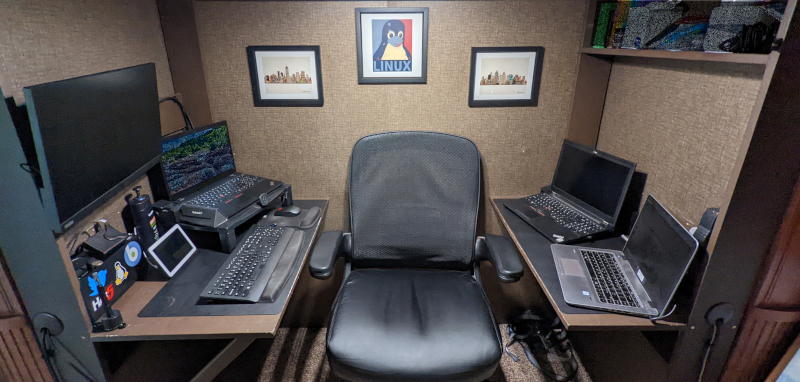 My custom dualing-desks setup inside a bunkhouse slide.